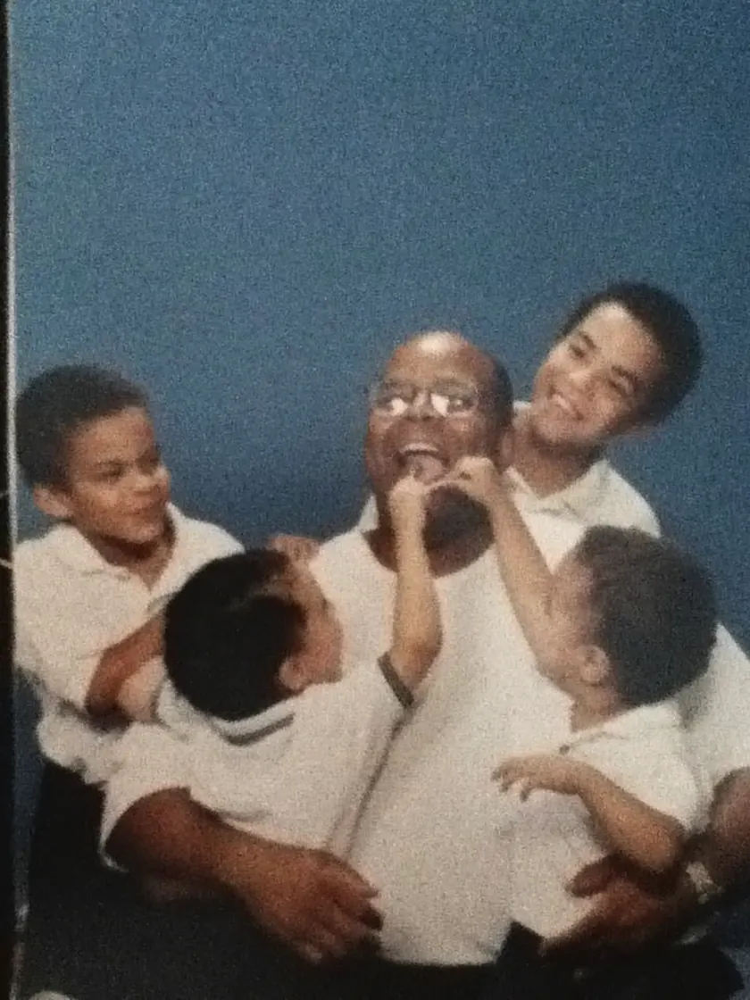 My father in a studio portrait with all four of us climbing on him.